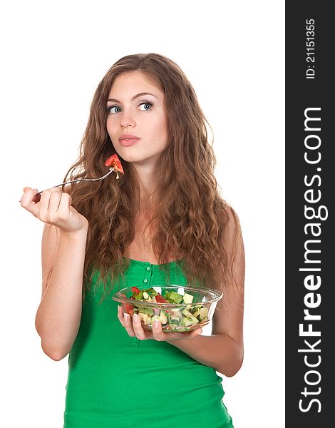 Portrait of attractive young thinking woman eating vegetable salad. Portrait of attractive young thinking woman eating vegetable salad