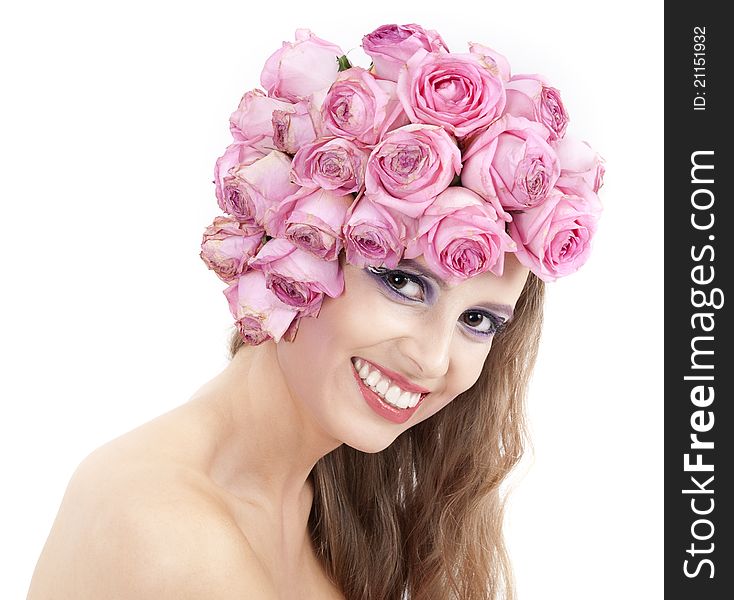 Young beautiful woman with pink flowers on her head over white