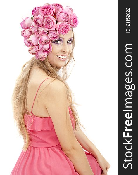 Young beautiful woman with pink flowers on her head over white