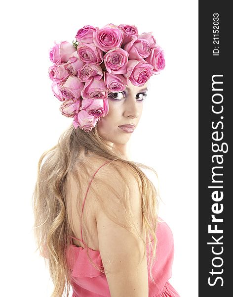 Young beautiful woman with pink flowers on her head over white