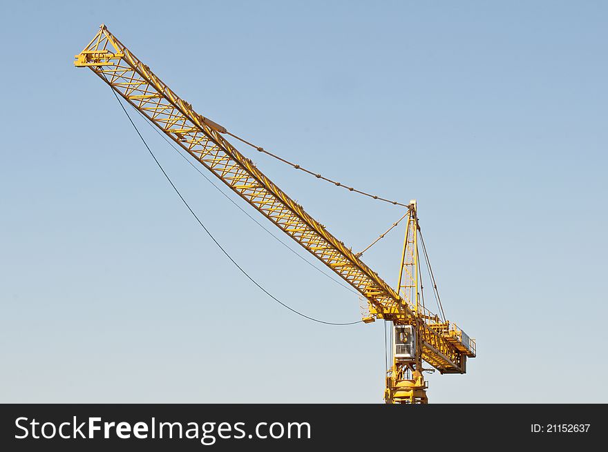 Yellow crane against blue sky - Construction site