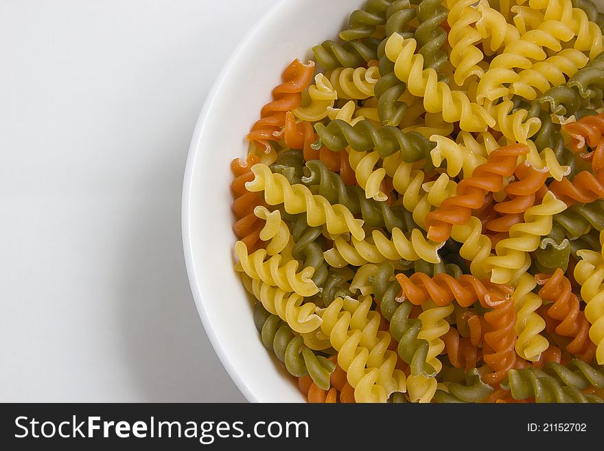 Fusilli pasta colored in a bowl