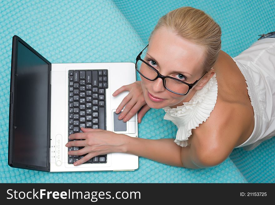 Woman in glasses with a laptop smiling top view. Woman in glasses with a laptop smiling top view