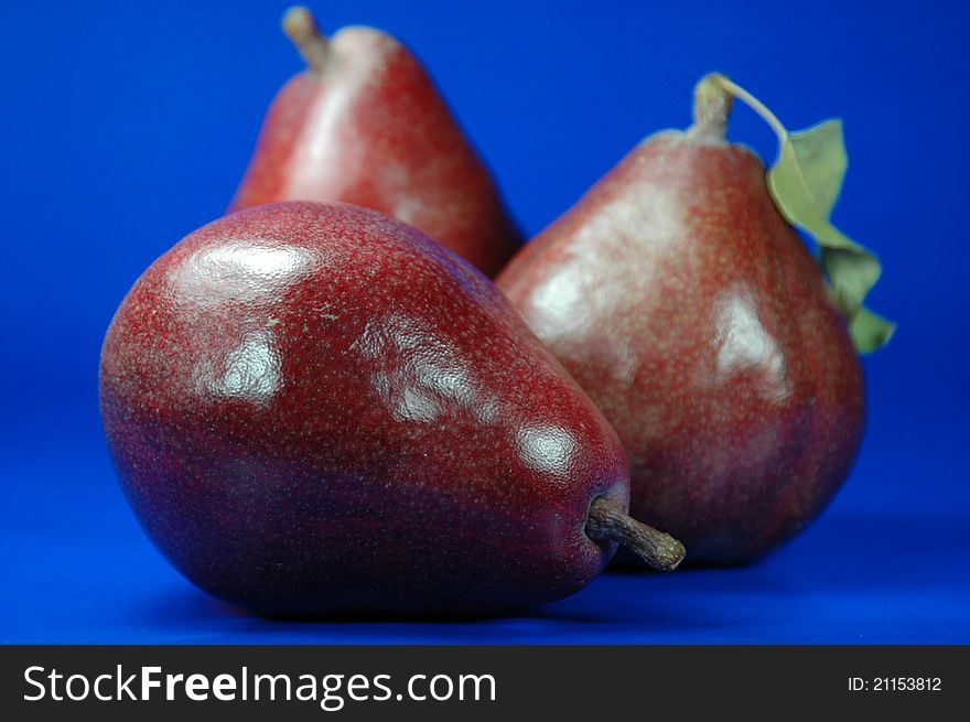 Three deep red pairs against a bright blue background. Three deep red pairs against a bright blue background