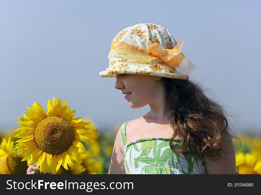 The Little girl and a beautiful sunflowers. The Little girl and a beautiful sunflowers