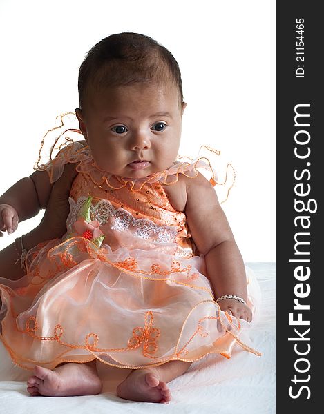 5 months old Baby girl dressed in cute pink dress on white background. 5 months old Baby girl dressed in cute pink dress on white background