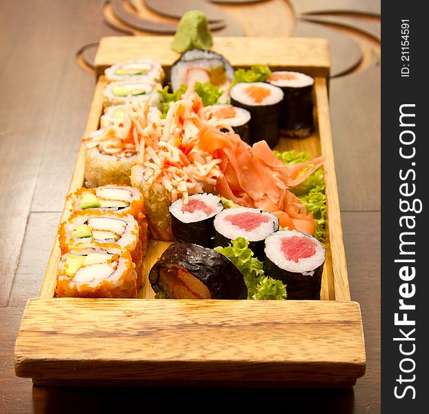 Different kinds of sushi on a wood plate