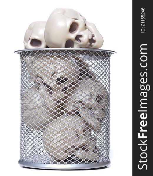 Plastic human skulls in a metal wastebasket waiting for halloween. Plastic human skulls in a metal wastebasket waiting for halloween