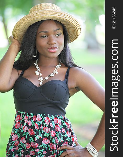 Image of a young black model with a straw hat. Image of a young black model with a straw hat
