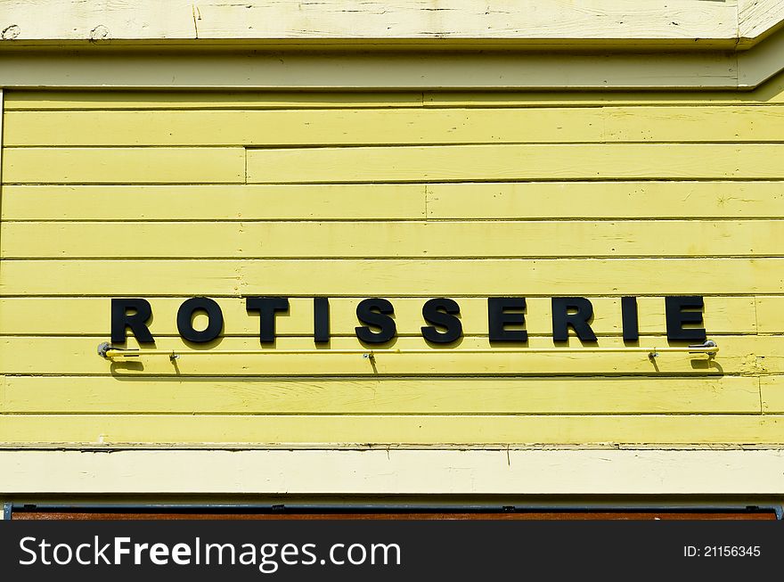 Rotisserie sign on wooden wall on grunge wooden wall