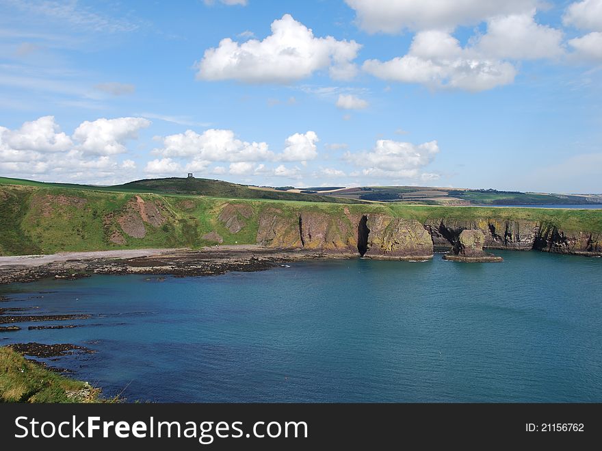 A view from Dunnottar Castle along the steep rocky shoreline of Grampian. A view from Dunnottar Castle along the steep rocky shoreline of Grampian