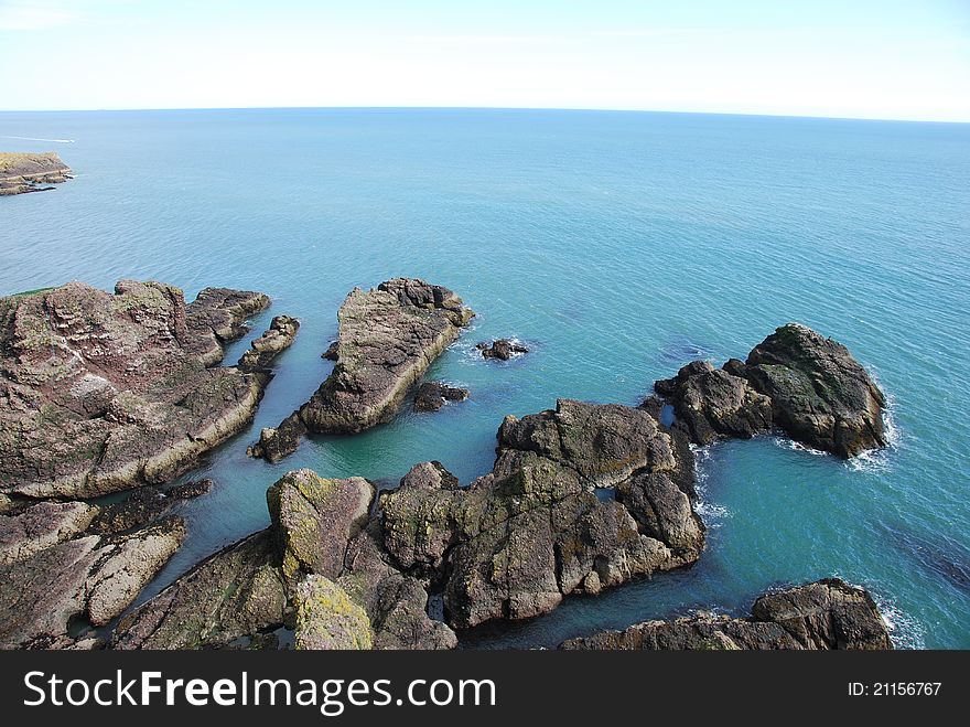 A view from Dunnottar Castle along the steep rocky shoreline of Grampian. A view from Dunnottar Castle along the steep rocky shoreline of Grampian