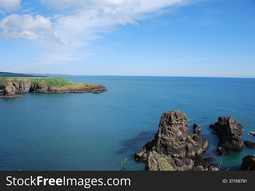 A view from Dunnottar Castle along the steep rocky shoreline of Grampian