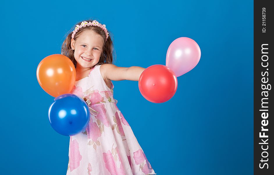 Happy Child With Colorful Air Ballons Over Blue