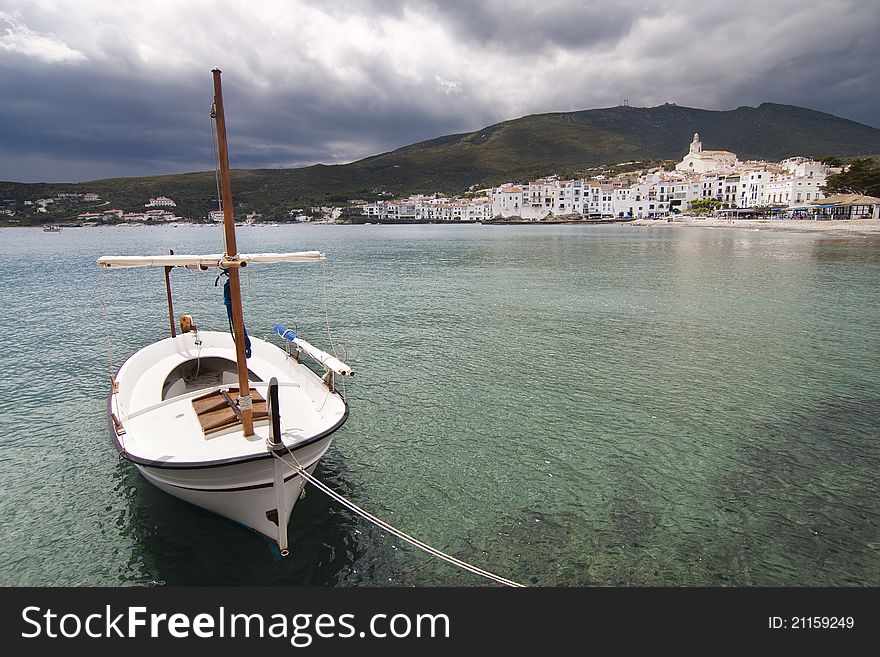 Not usual view of cadaques with a lonely boat in left hand.
