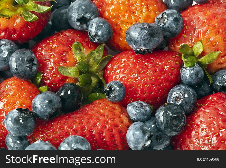 Garden strawberry, Fragaria Ã— ananassa with blueberries. Garden strawberry, Fragaria Ã— ananassa with blueberries