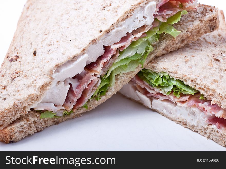 Sandwich with bacon,chicken and vegetables on white background. Sandwich with bacon,chicken and vegetables on white background