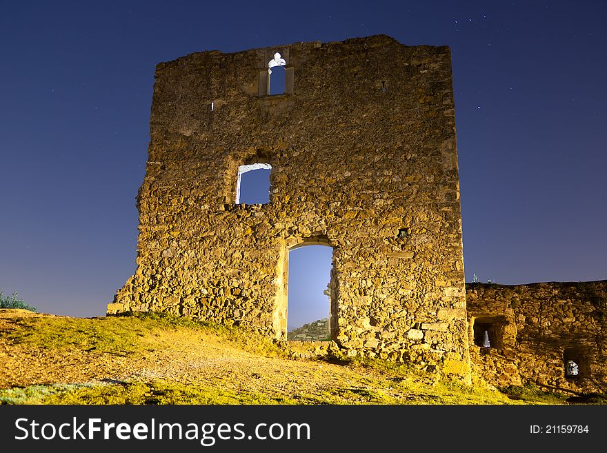 Low-angle shoot of old ruins of a castle at night. Low-angle shoot of old ruins of a castle at night