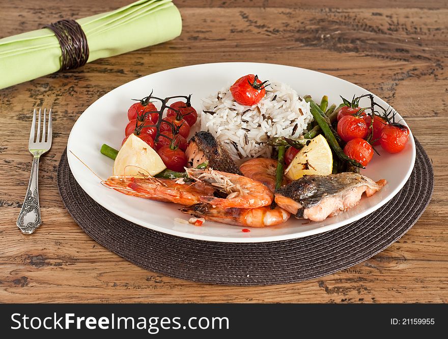 Roast fish fillet with prawns, asparagus and tomatoes. Roast fish fillet with prawns, asparagus and tomatoes