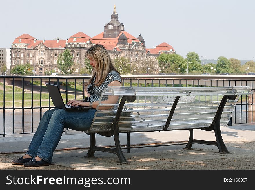 Girl with laptop in Dresden on the bank of the Elbe. Germany