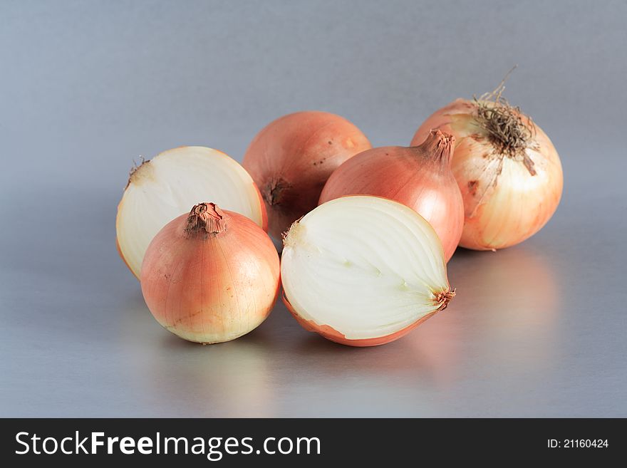 Closeup of few onions on beautiful gray background