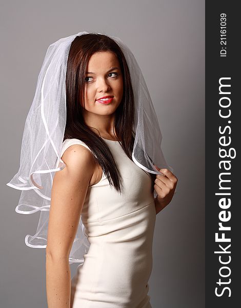 Beautiful young girl in a beautiful dress and white veil