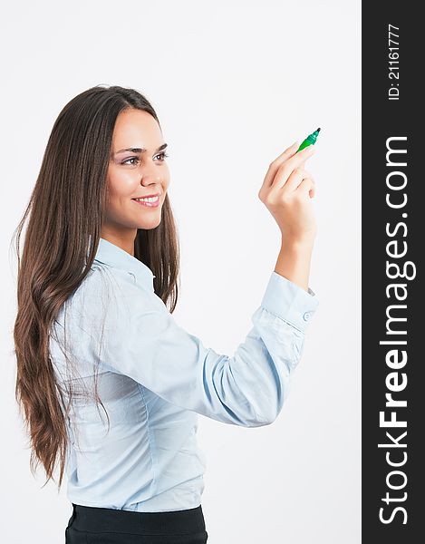 Happy smiling cheerful young business woman writing or drawing on screen with green marker, on white background