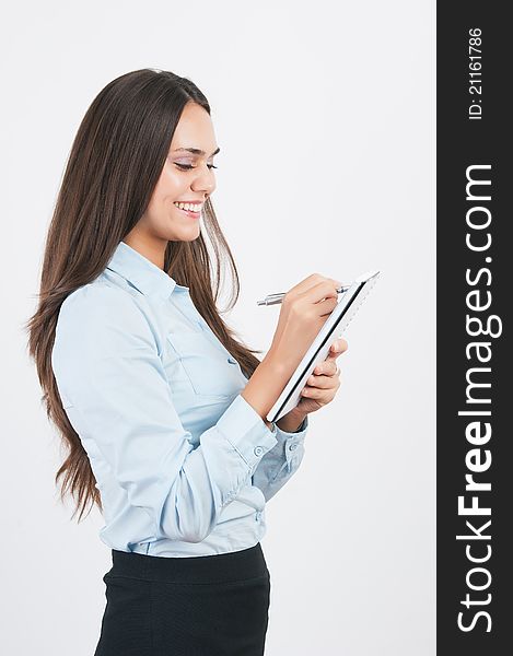 Happy smiling young businesswoman with clipboard writing, on white background. Happy smiling young businesswoman with clipboard writing, on white background