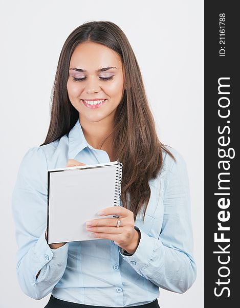 Happy smiling young businesswoman with clipboard writing, on white background. Happy smiling young businesswoman with clipboard writing, on white background