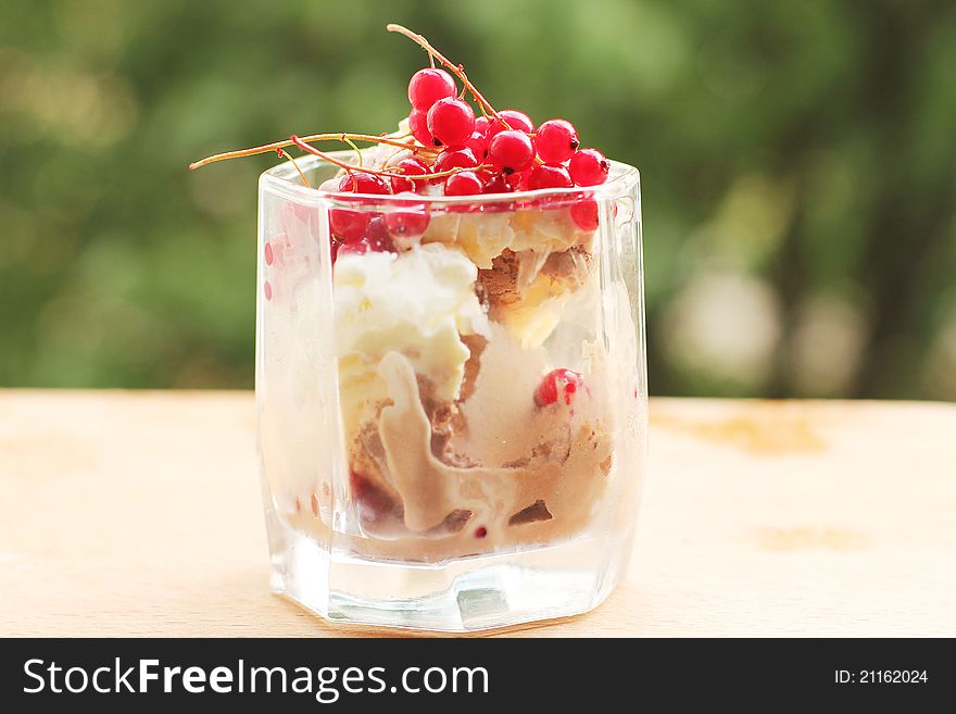 Ice cream in a glass with red currants
