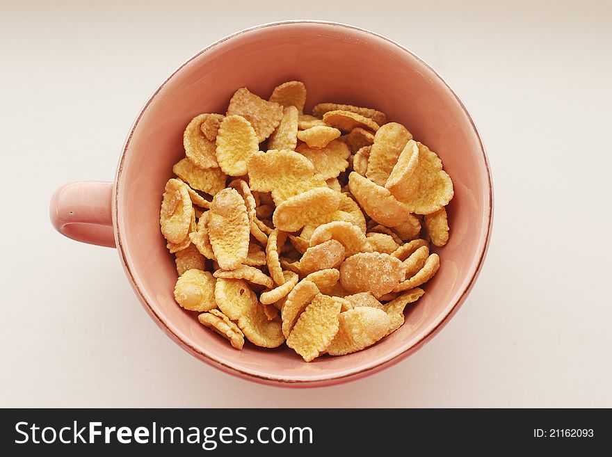 Cornflakes in a pink bowl