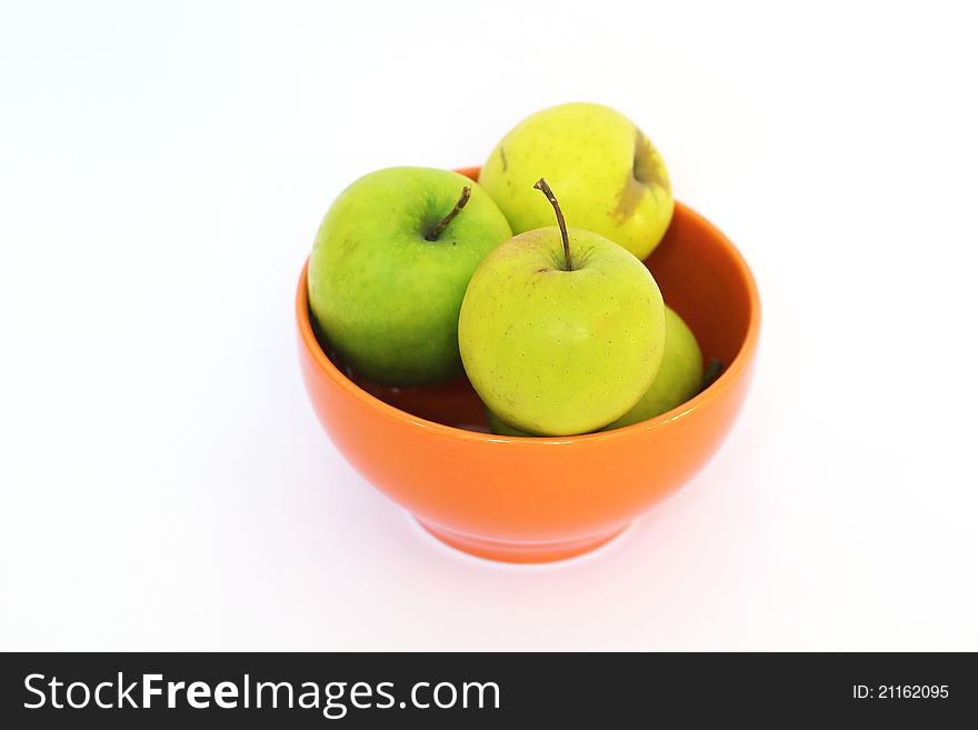 Green apples in an orange Bowl