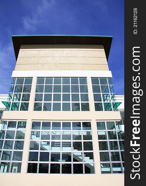 Clear glass wall of a building shaped in many squares, with bluesky background. Staircase inside the building can be seen from the outside view. Clear glass wall of a building shaped in many squares, with bluesky background. Staircase inside the building can be seen from the outside view.