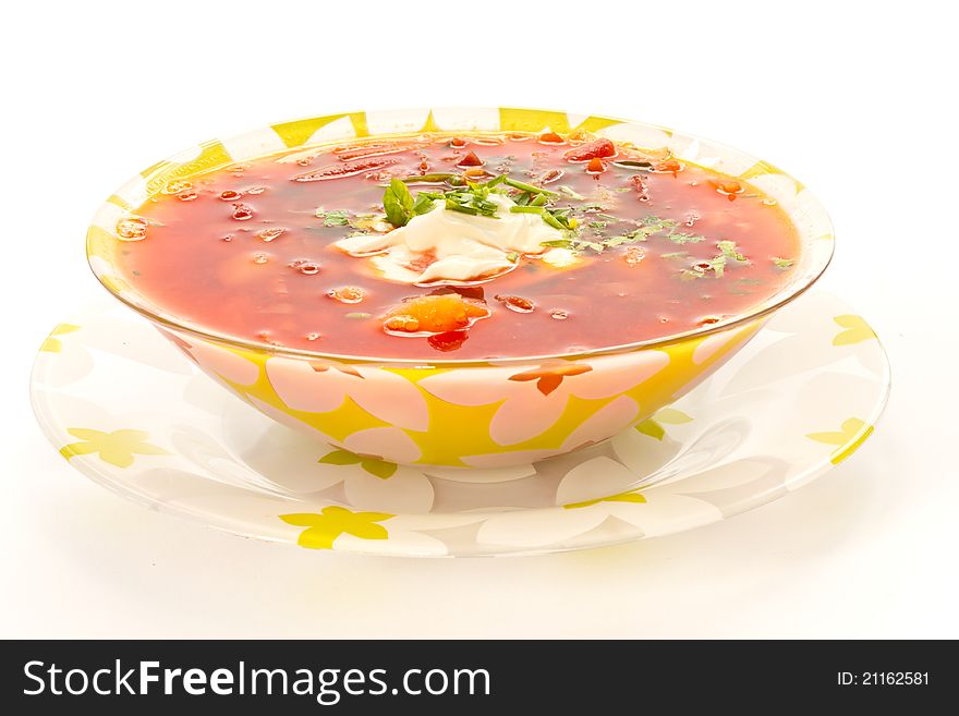 Fresh hot beet borscht with sour cream and herbs