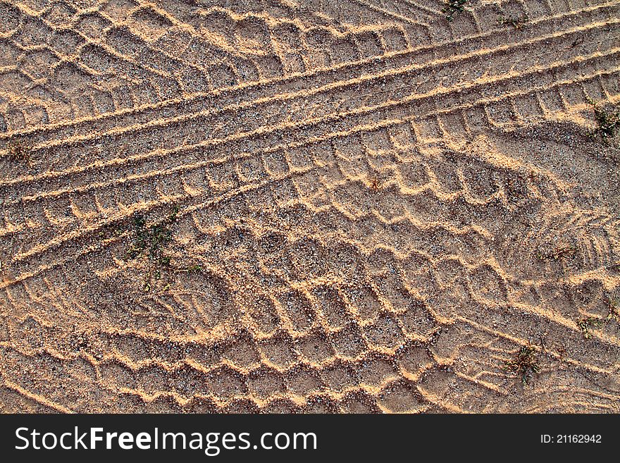 Tire tracks and shoe tracks in sand