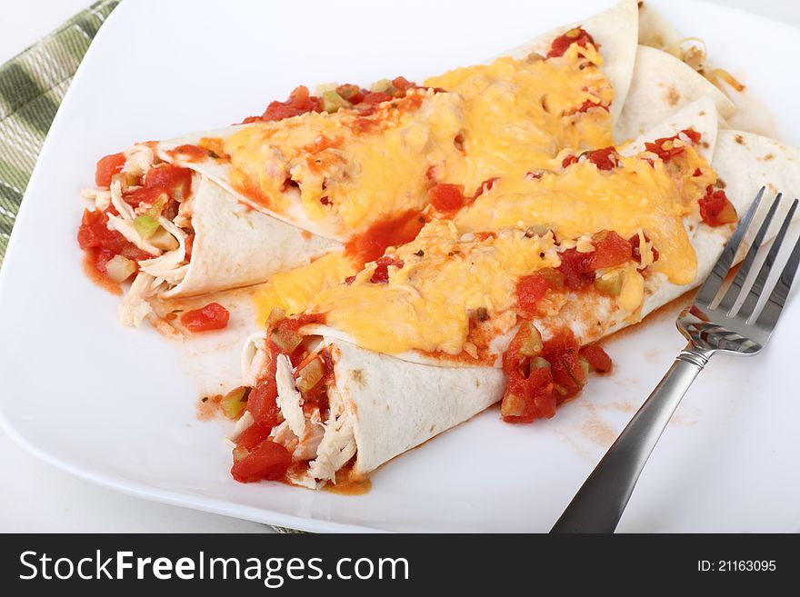 Two chicken fajitas covered with cheese sauce. Two chicken fajitas covered with cheese sauce