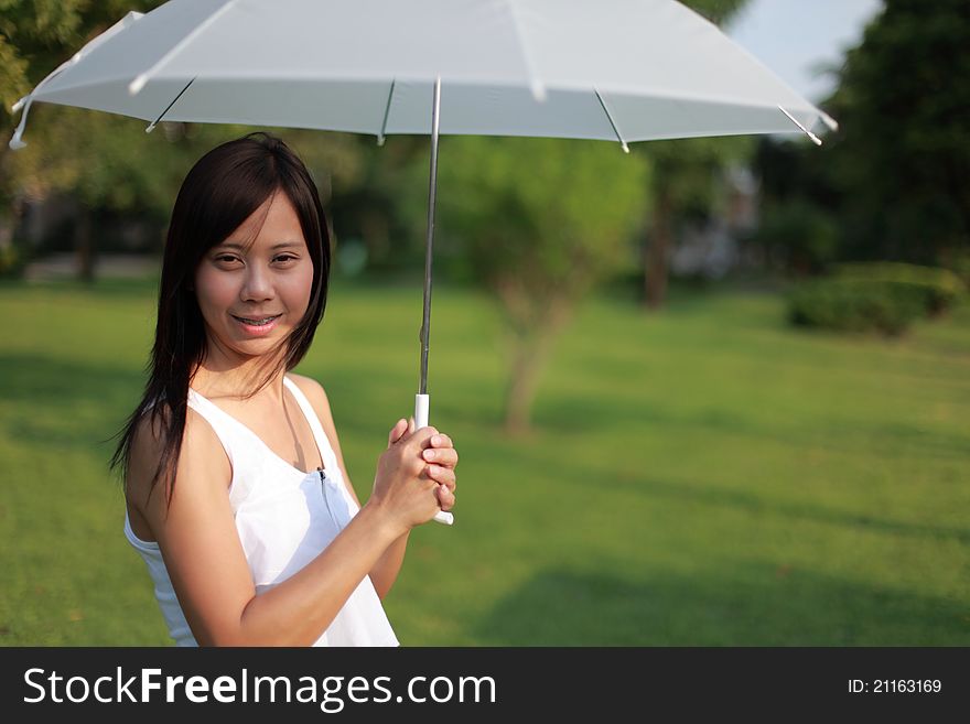 Woman and white umbrella in the garden. Woman and white umbrella in the garden