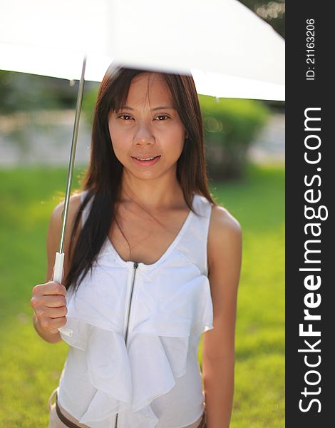 Woman and white umbrella in the garden. Woman and white umbrella in the garden