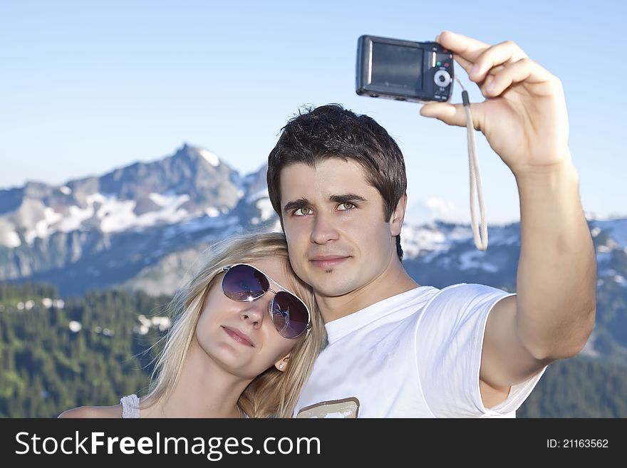 Portrait of a young happy couple together on the mount photographed themselves. Portrait of a young happy couple together on the mount photographed themselves