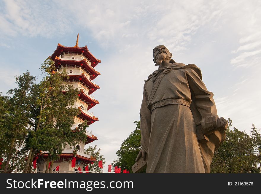 Historical Chinese statue and traditional Oriental pagoda in Chinese Garden. Historical Chinese statue and traditional Oriental pagoda in Chinese Garden.