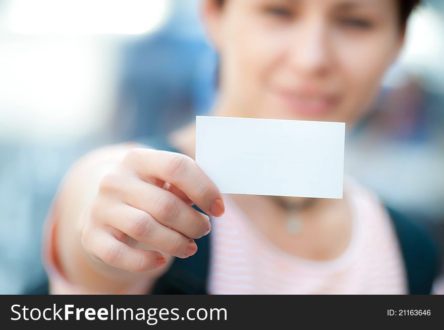 White card in a hand on a blur background