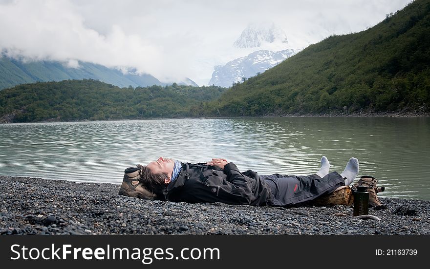 Man Resting By Lake Mountain