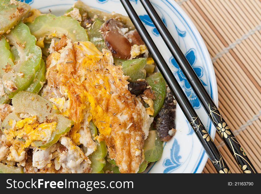 Special delicacy of omelet fried with healthy ingredients of bittergourd and mushrooms. Special delicacy of omelet fried with healthy ingredients of bittergourd and mushrooms.