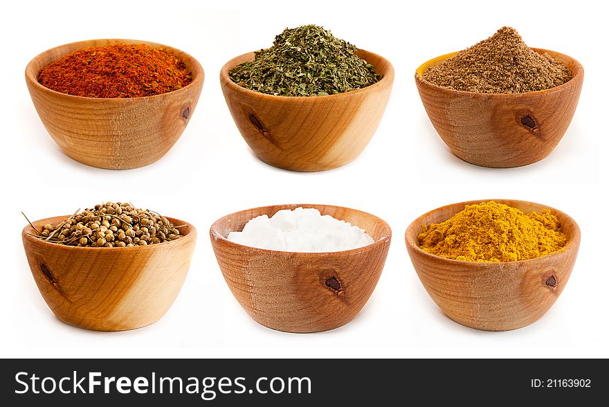 Spices in a wooden platter isolated on a white background