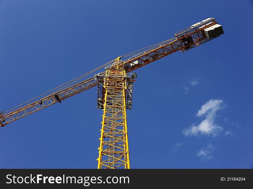 Tower crane in the blue sky