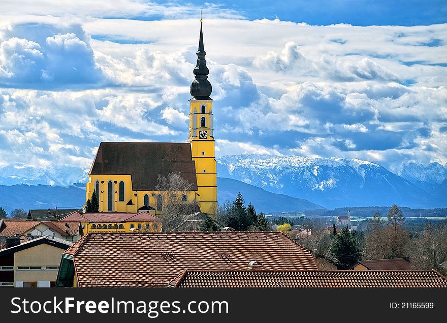 Alpine landscape with big catholic cathedral and mountains in background near Salzburg, Austria. Alpine landscape with big catholic cathedral and mountains in background near Salzburg, Austria