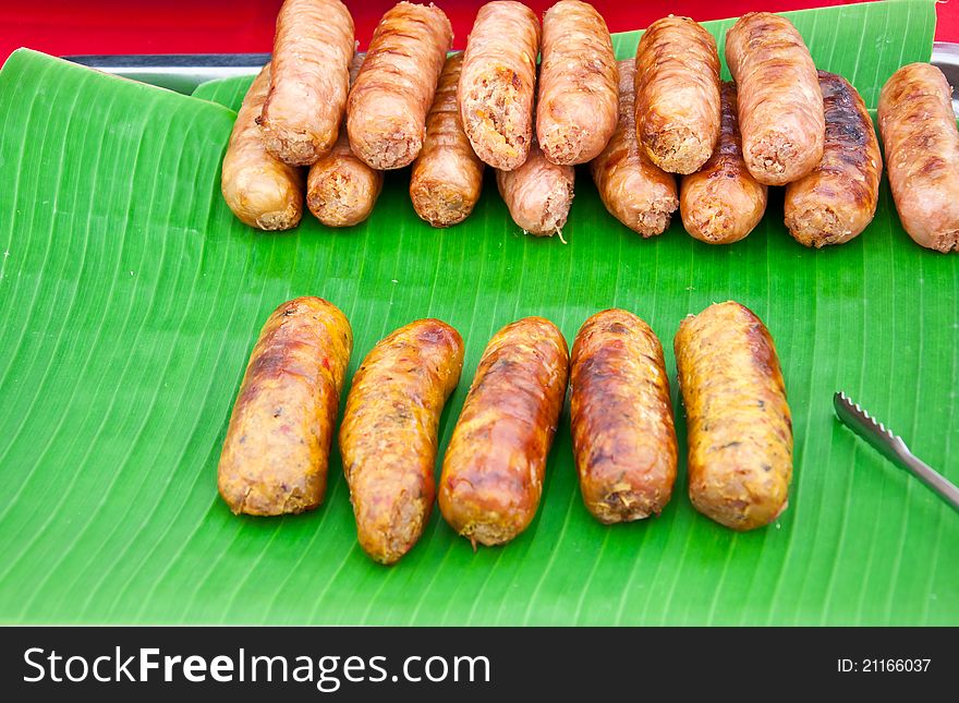 This is roasted sausage on banana leaves background. This is roasted sausage on banana leaves background