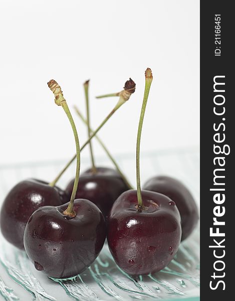 Macro fresh cherry on glass plate