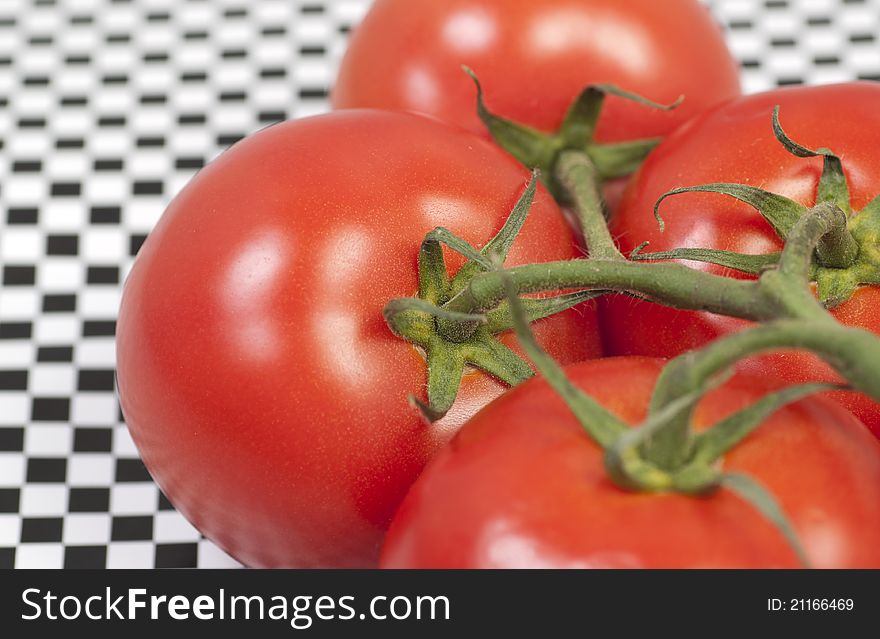 Isolated fresh tomatoes on pattern background