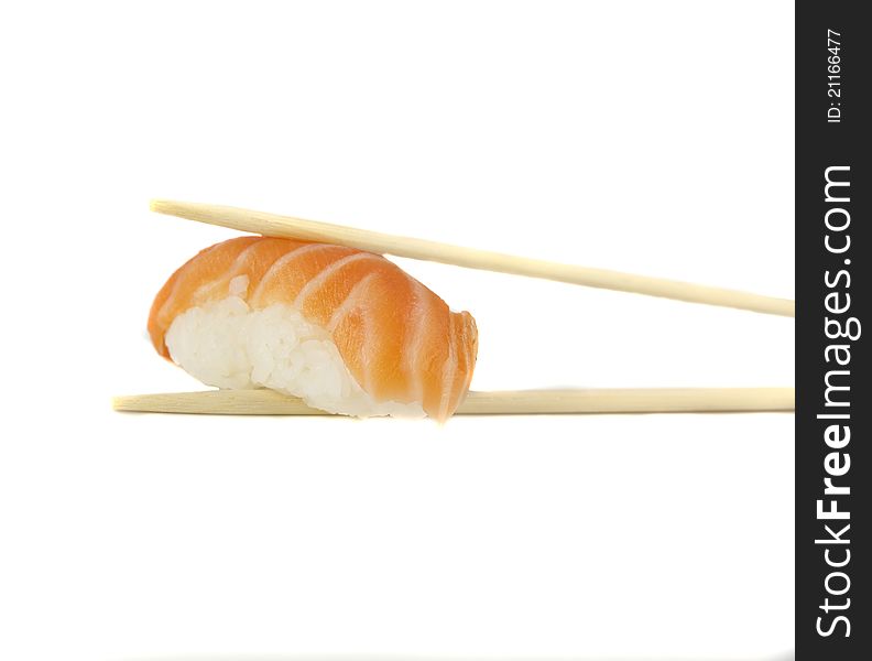 Nigiri sushi with salmon between two chopsticks